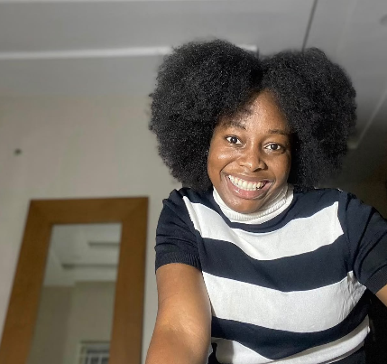 Treasure smiling with her full natural afro