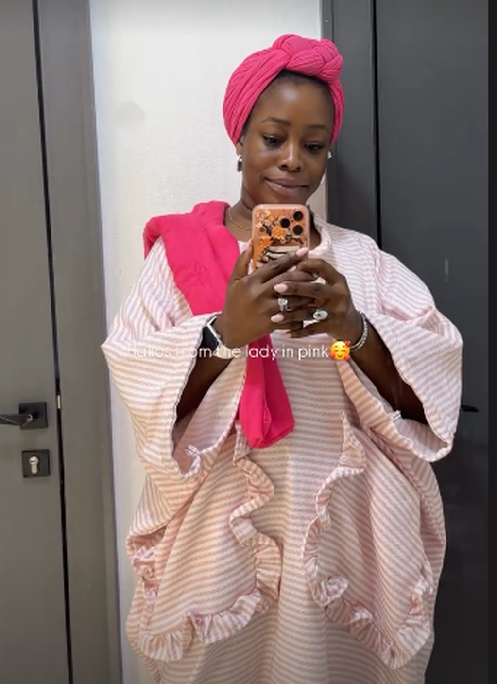Treasure in a pink striped kaftan and headwrap